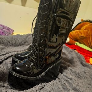 YRU platform vinyl boots with pockets and straps on the sides